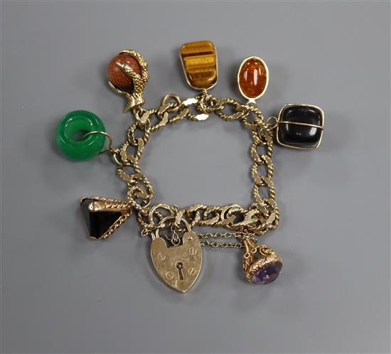 A 9ct gold charm bracelet with padlock clasp and seven assorted charms
